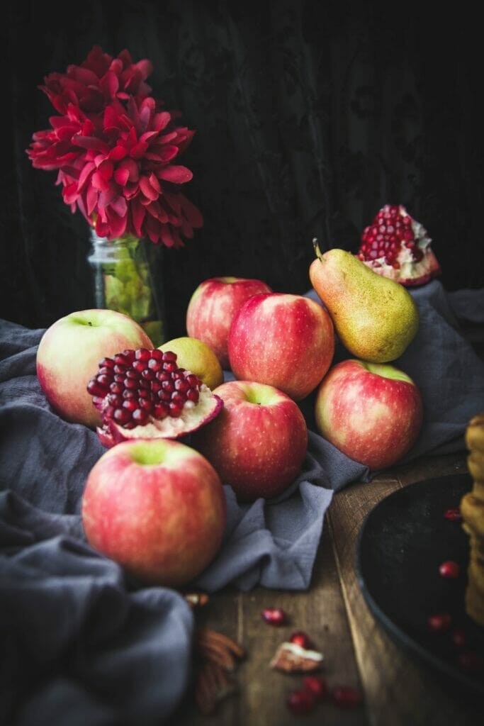 stack of apples, pears, and pomegrantes