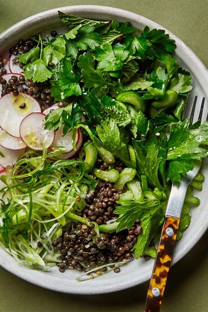 bowl with lentils and fresh green herbs