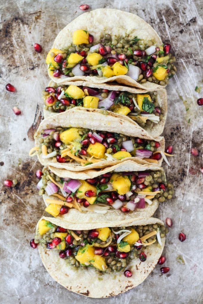 5 tacos with mango salsa on a cookie sheet