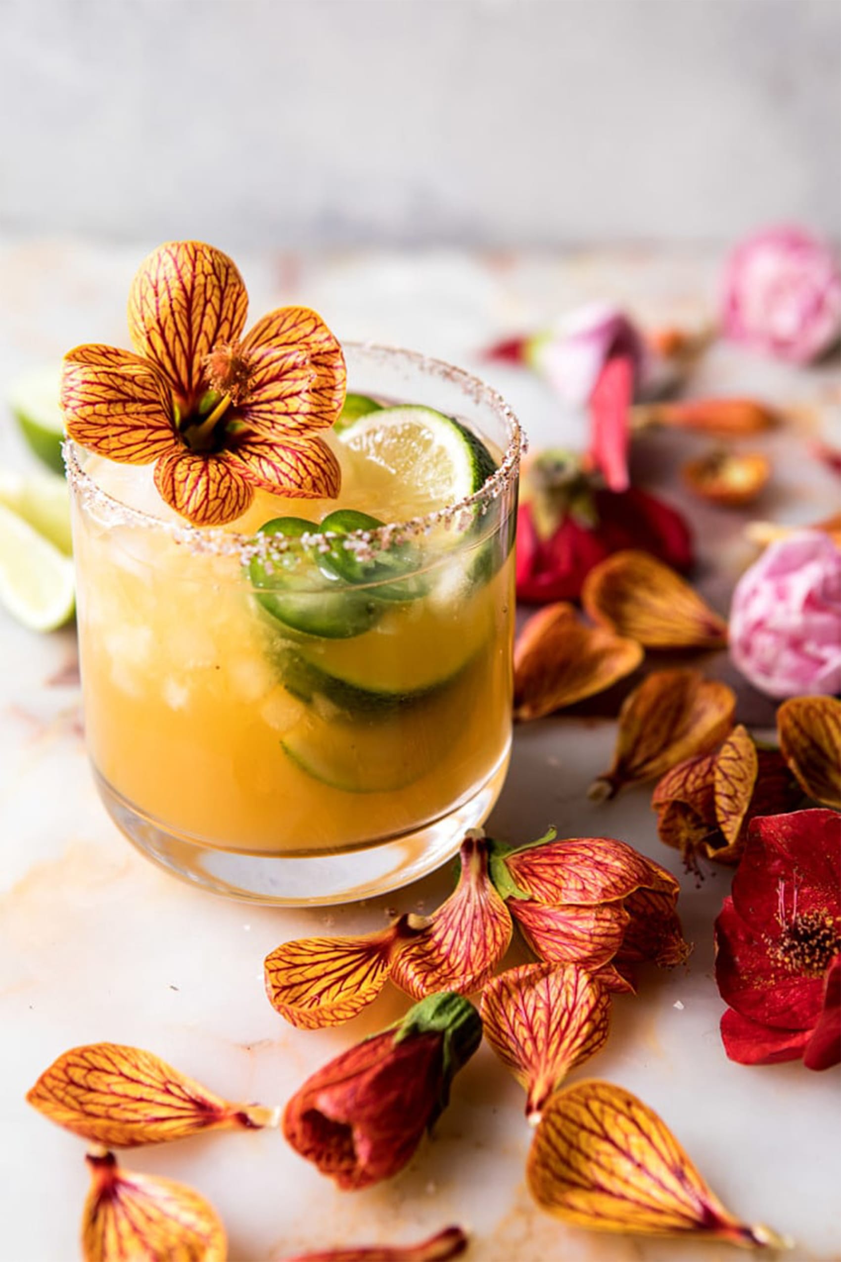 mango margarita with flowers on a table