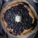 overhead shot of vegan berry galette with a scoop of ice cream in the center on a piece of parchment