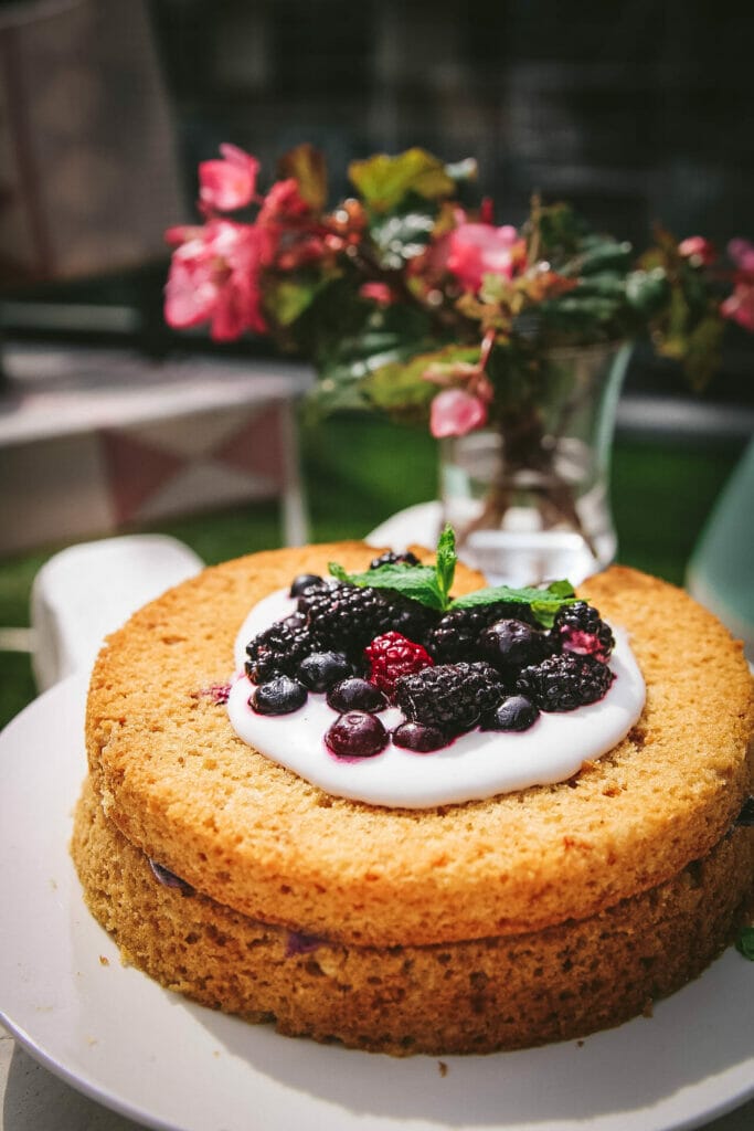 side view of vegan olive oil cake with mixed berries