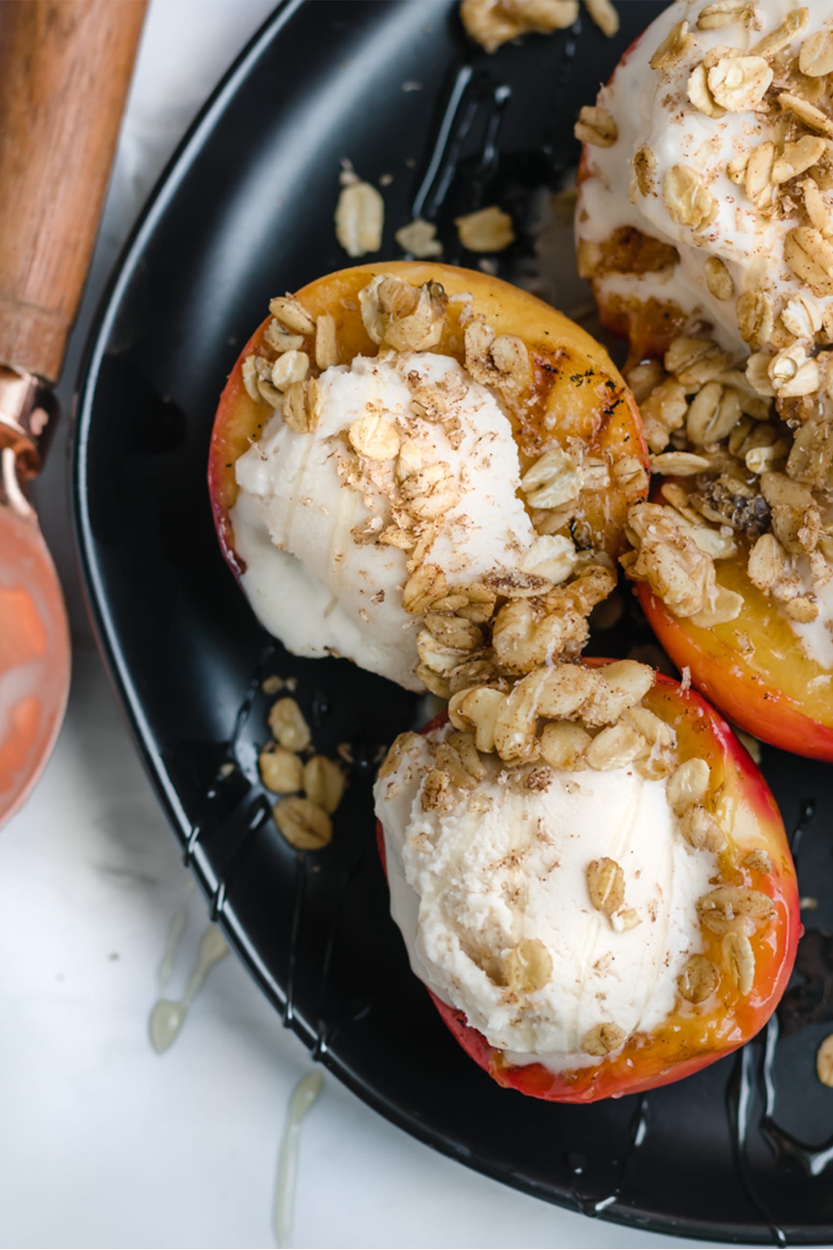 grilled peaches on a plate with cinnamon crispies