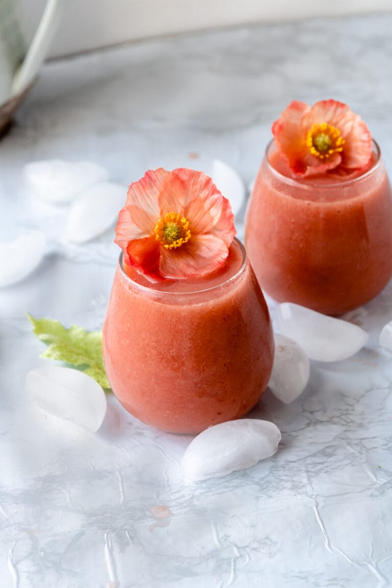 two glasses of frose with orange flowers