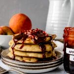 stack of pancakes with apple cider syrup dripping down