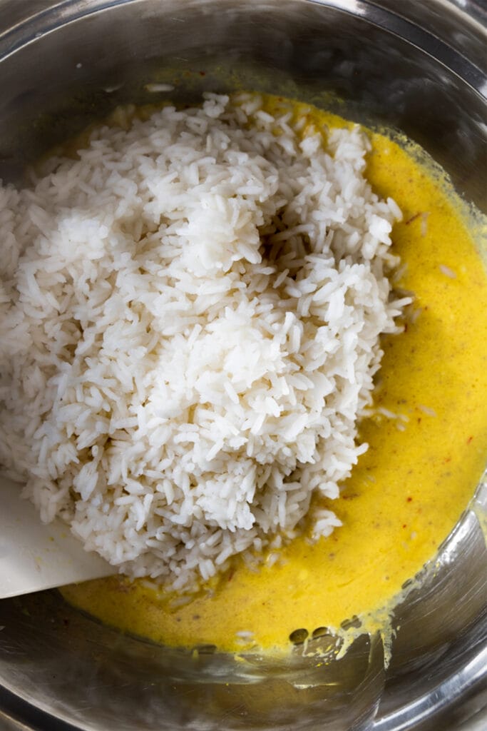 overhead shot of white basmati rice in a yellow saffron mixture