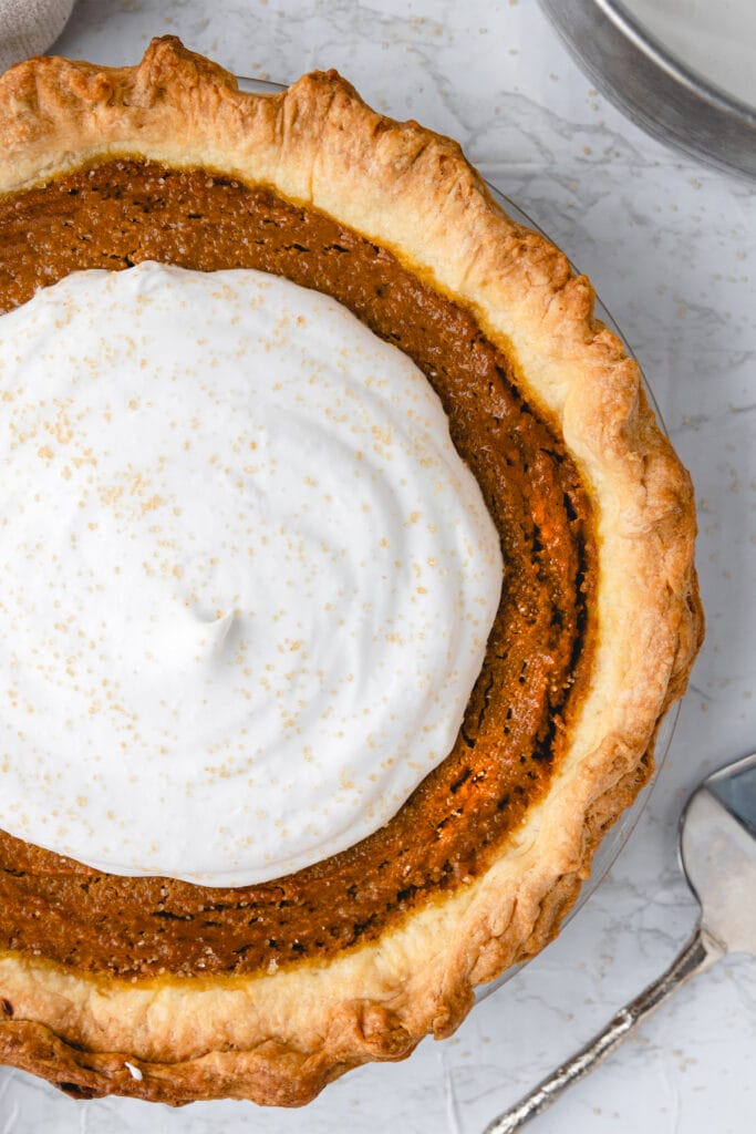 vegan pumpkin pie with dairy free whipped cream made with coconut cream