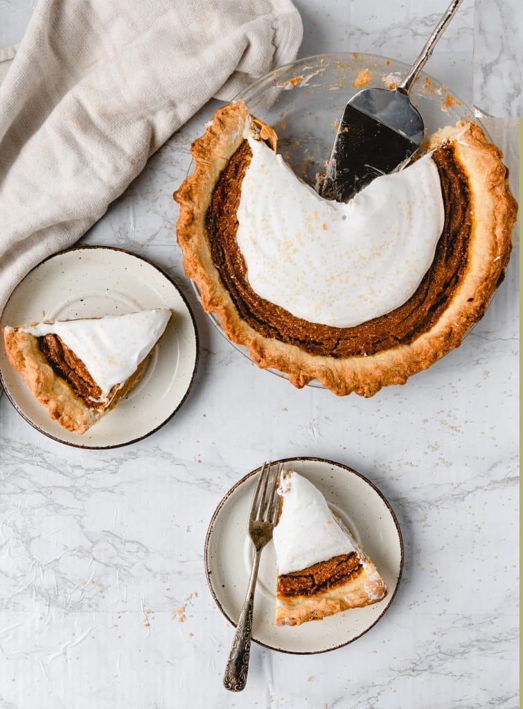 one vegan pumpkin pie with two slices on plates