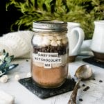 mason jar filled with vegan hot cocoa mix, topped with chocolate chips and marshmallows