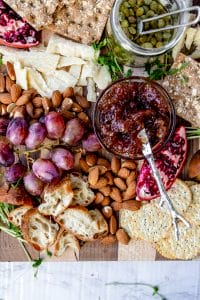 overhead shot of fig jam on a vegan cheese board with a sliver knife