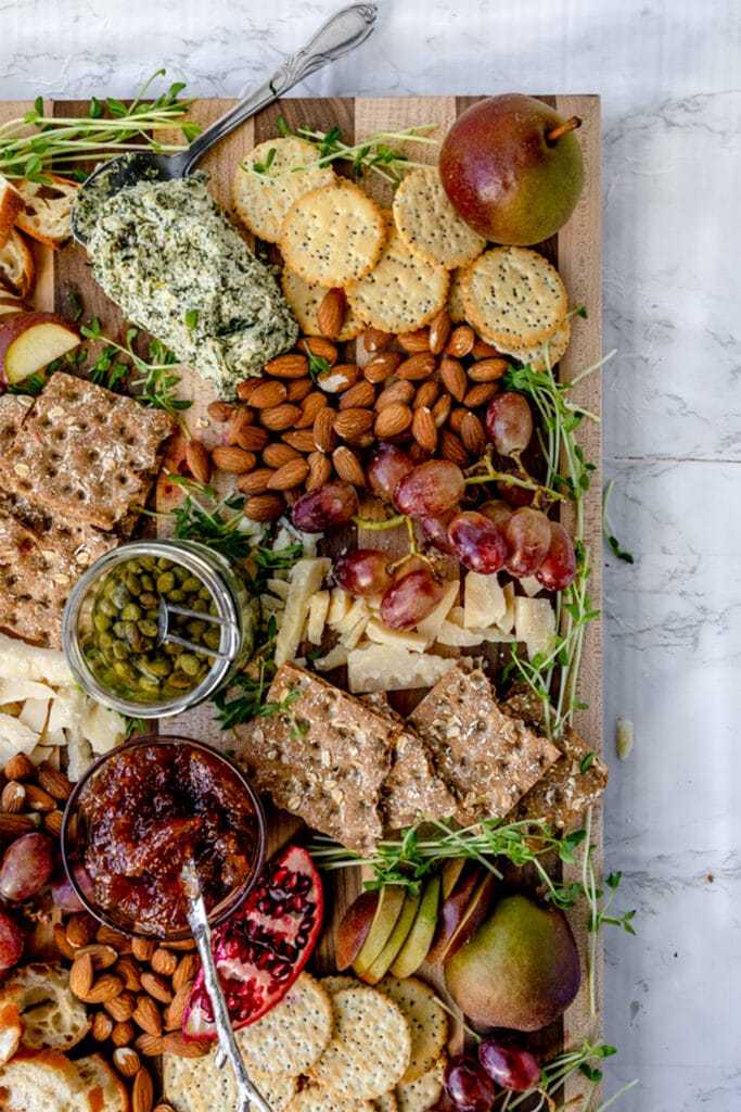 overhead shot of vegan cheese board with almonds and capers