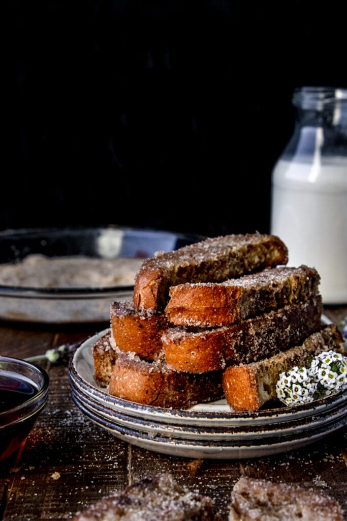 plate of cinnamon sugar french toast sticks next to a glass of milk