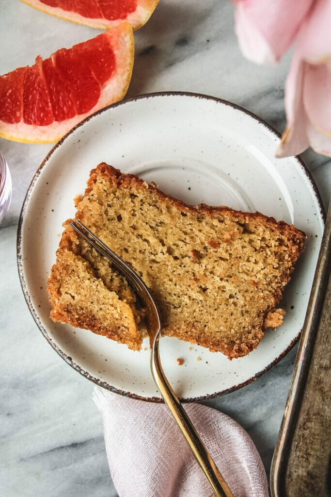 slice of grapefruit poppyseed cake with a fork