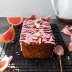grapefruit poppyseed olive oil loaf cake on a cooling rack with a golden spoon