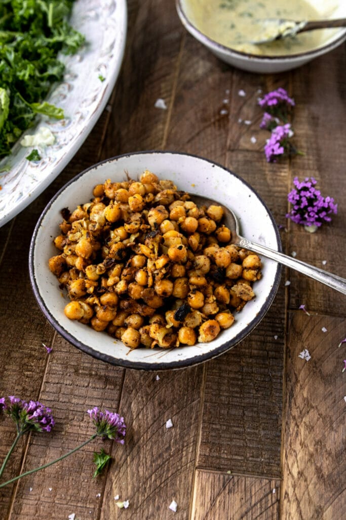 bowl of crispy chickpeas with silver spoon