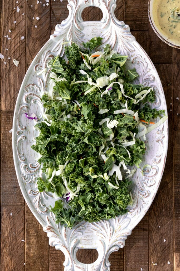 plate of kale and cabbage on wood board