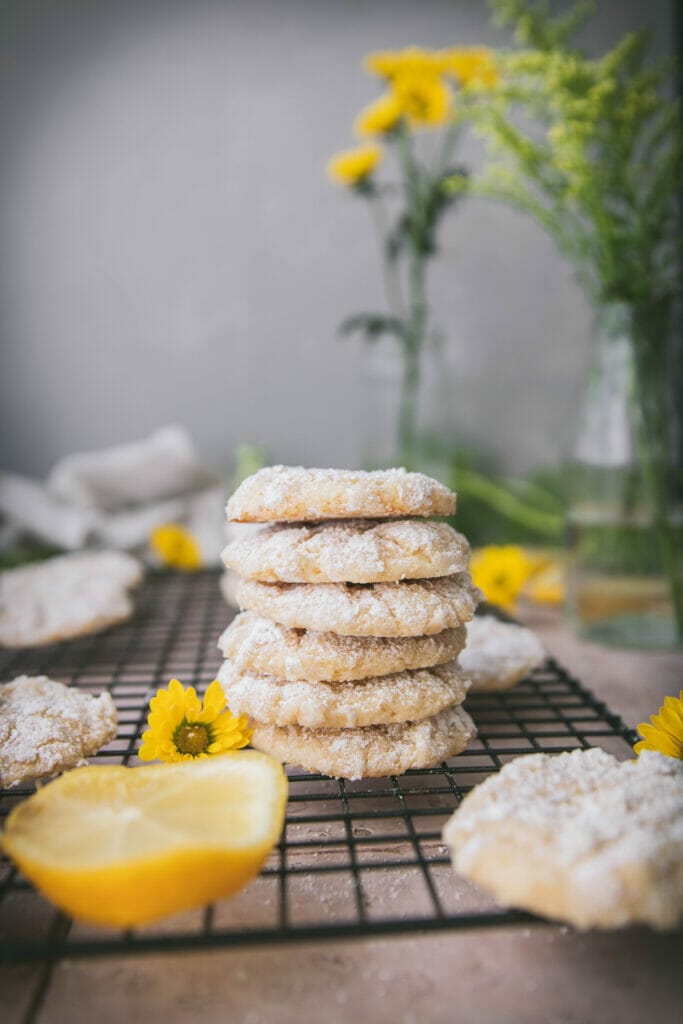 stack of six vegan lemon crinkle cookies on a wire rack