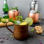 three extra gingery moscow mules garnished with mint and limes