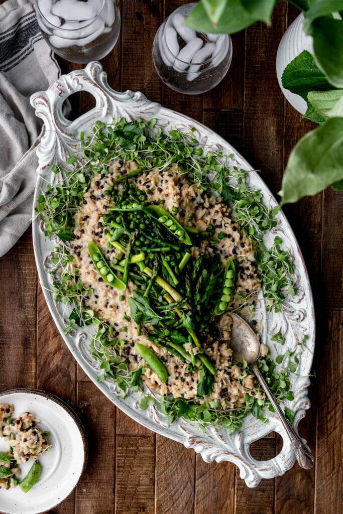 overhead shot of asparagus barley risotto and a wooden table