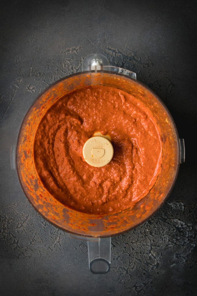 overhead shot of roasted red pepper romesco sauce in a food processor