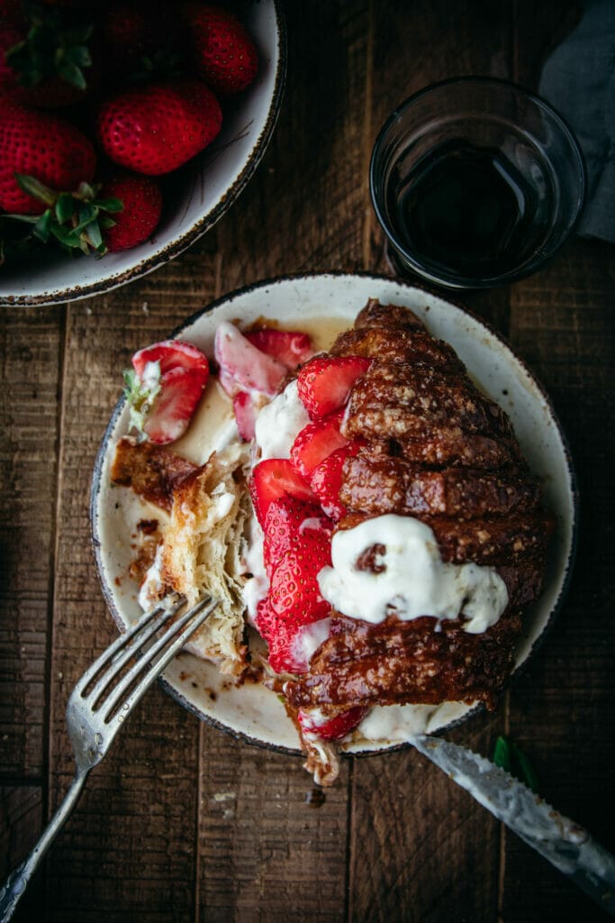 overhead shot of cinnamon crunch croissant french toast with a fork