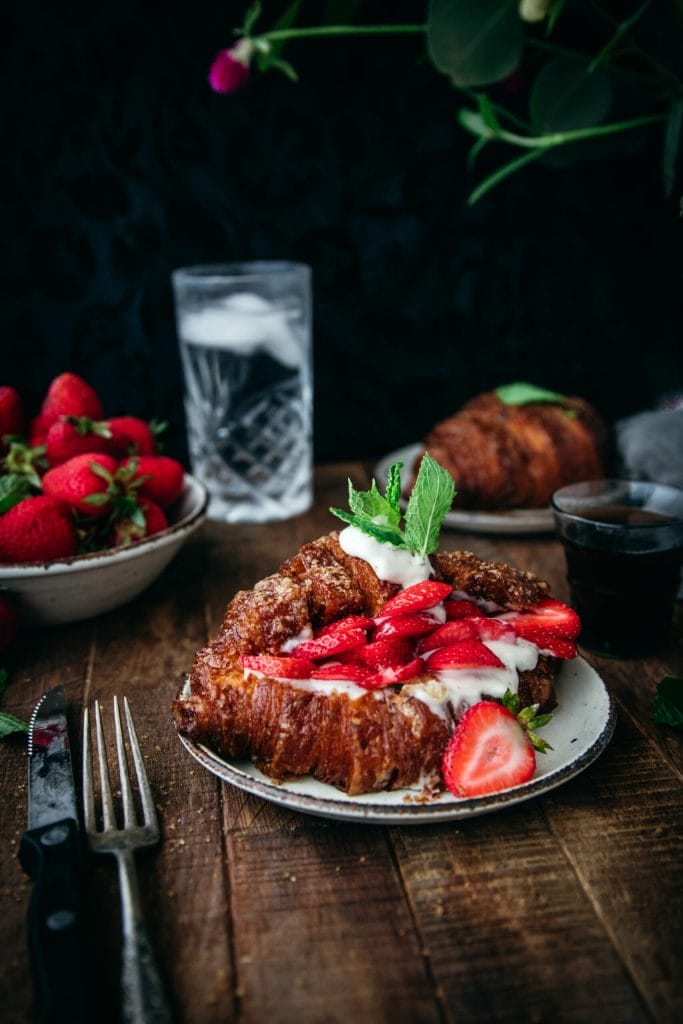 crispy golden baked croissant with strawberries and mint