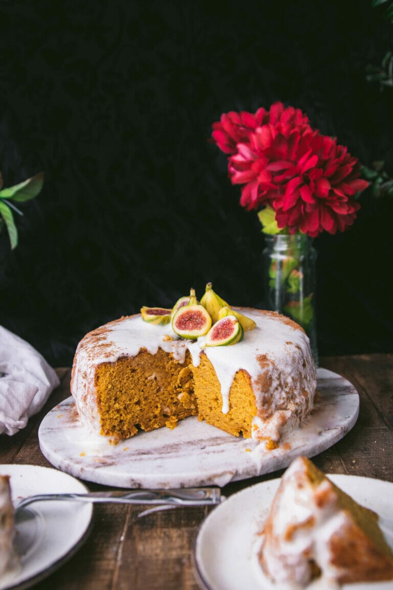 vegan pumpkin cake on a tray topped with brown butter frosting