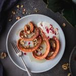 overhead shot of turkish candied pumpkin on a plate with yogurt and pomegranate