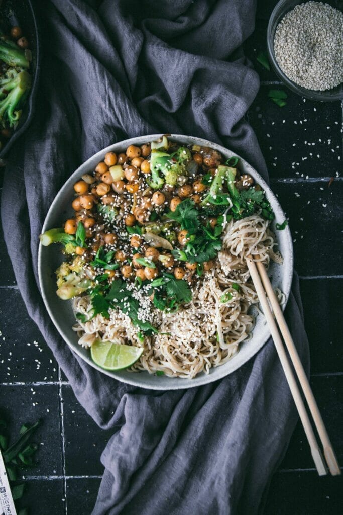 overhead view of a bowl of black pepper chickpeas with noodles