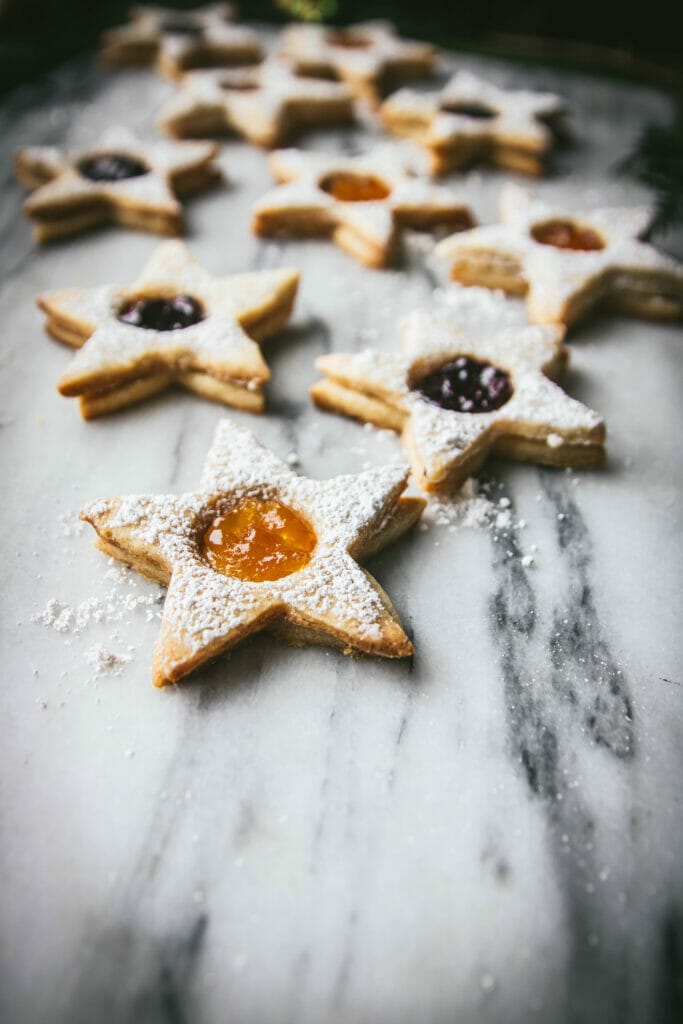 side view of star shaped linzer cookie with apricot jam cutout