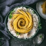 overhead view of vegan mango sticky rice in a green bowl