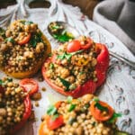 plate of vegan stuffed peppers with couscous and herbs