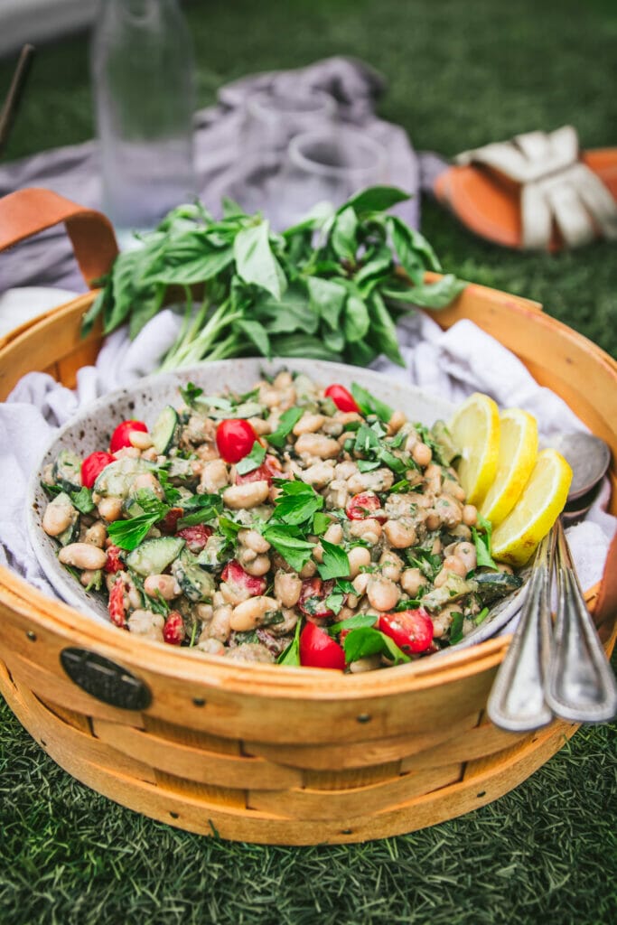 side view of pesto white bean salad in a basket