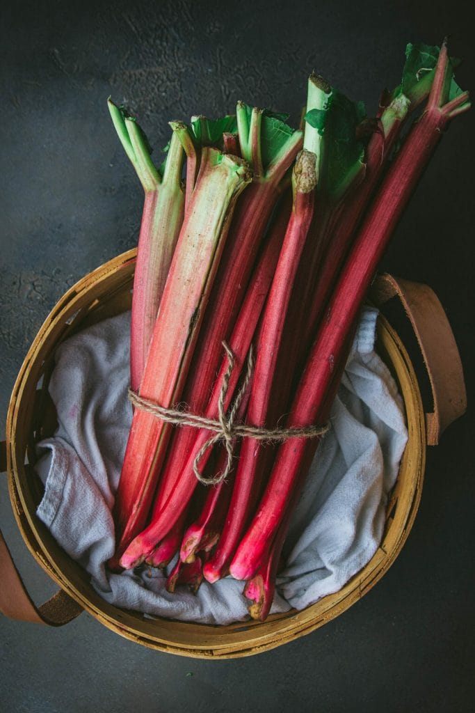 a basket of rhubarb stalks tied with twine
