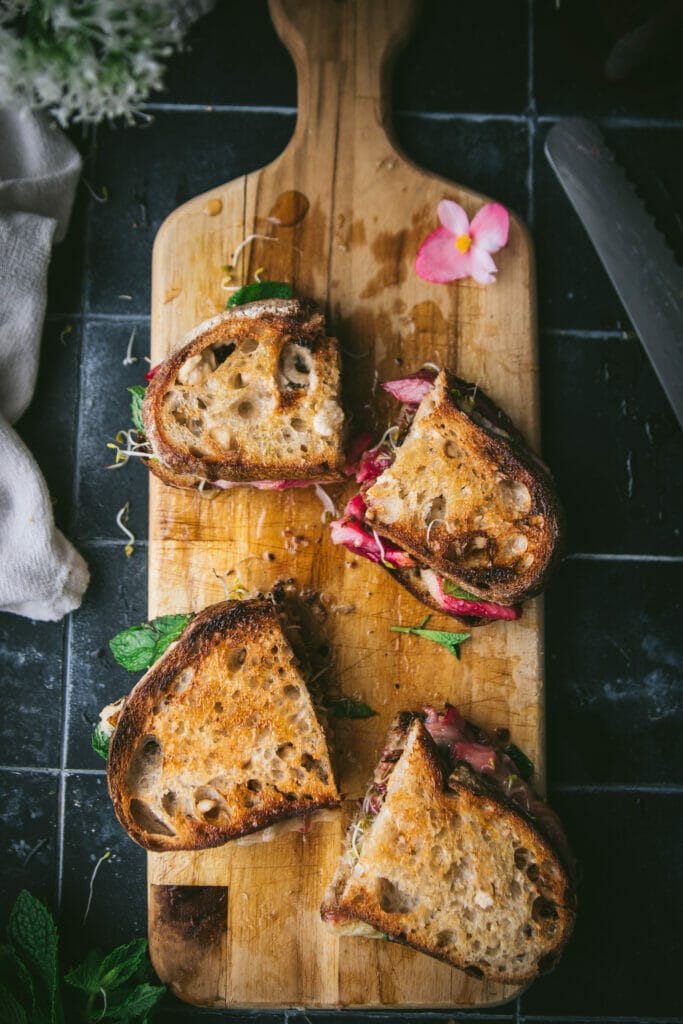 and overhead shot of two roasted rhubarb sandwiches on a board