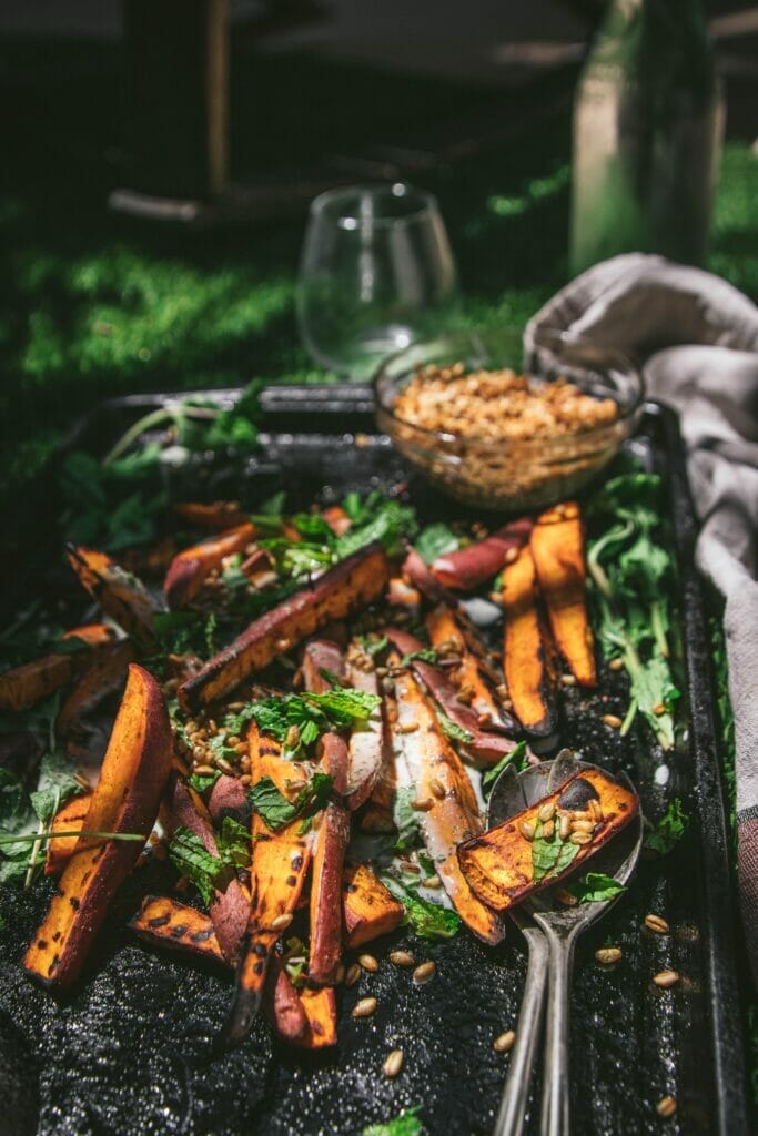 side view of a tray of grilled sweet potato salad with mint and yogurt dressing