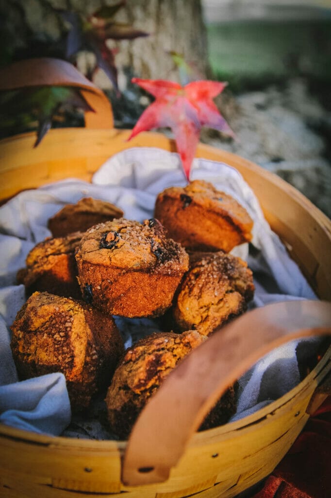 a close up of cinnamon swirl pumpkin muffins in a basket