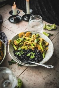 bowl of turmeric cauliflower and peas on a table