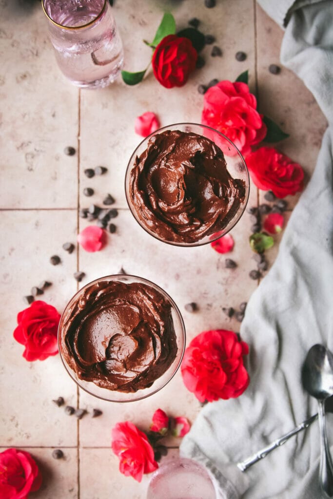 vegan chocolate pudding on a table with pink roses