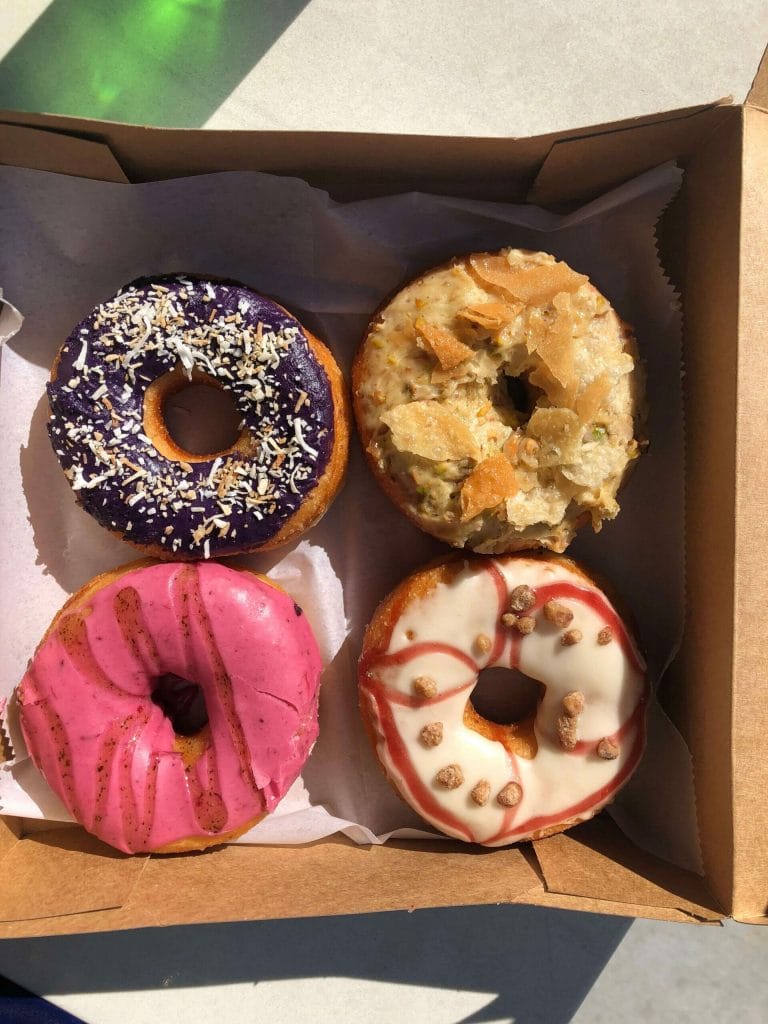 four multicolored vegan donuts from Nomad