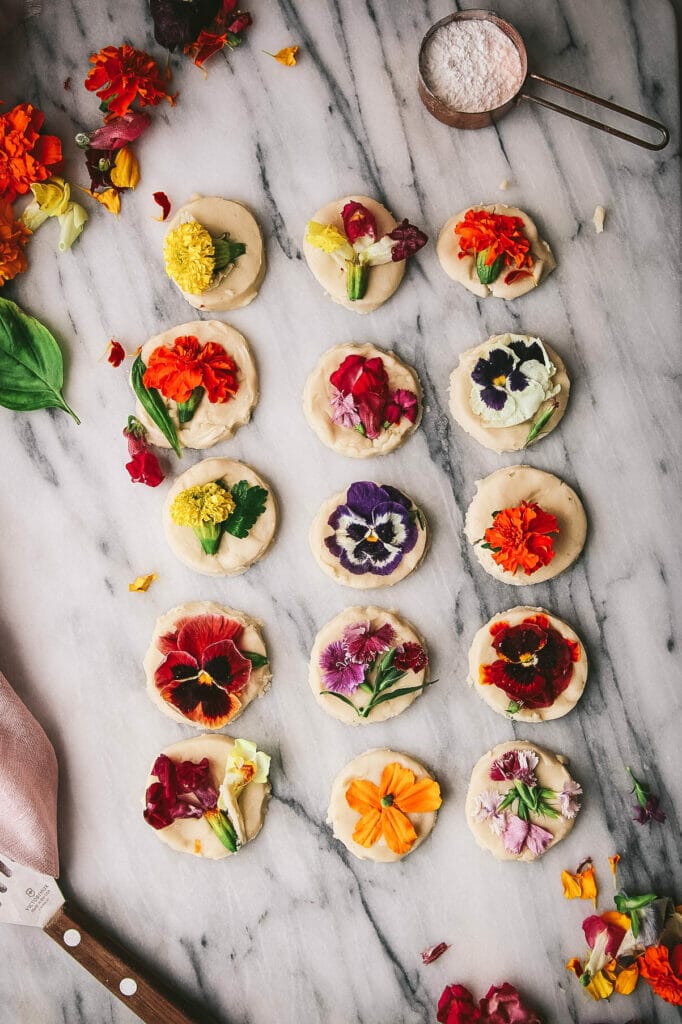 overhead view of flower shortbread cookies on a marble tray