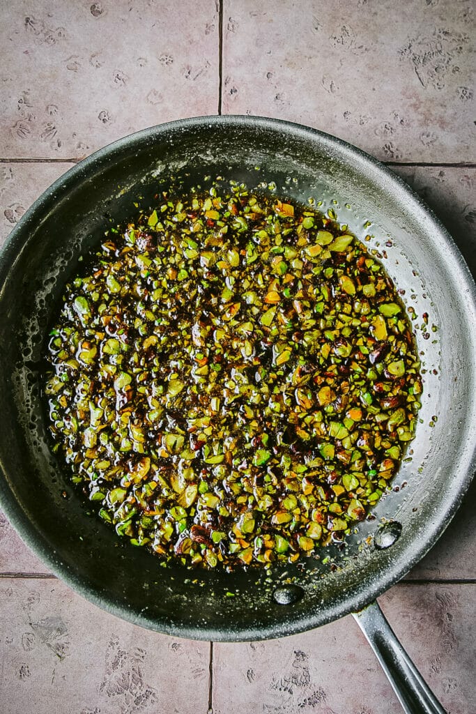 skillet of candied pistachios for pistachio syrup