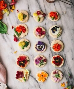 overhead view of flower shortbread cookies on a marble tray