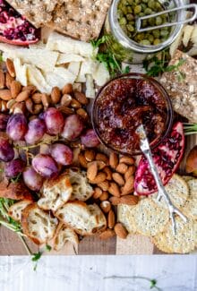 overhead shot of fig jam on a vegan cheese board with a sliver knife