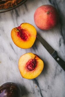 sliced peach next to a paring knife