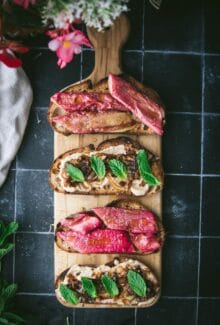 four pieces of toasted bread topped with rhubarb and cashew cheese