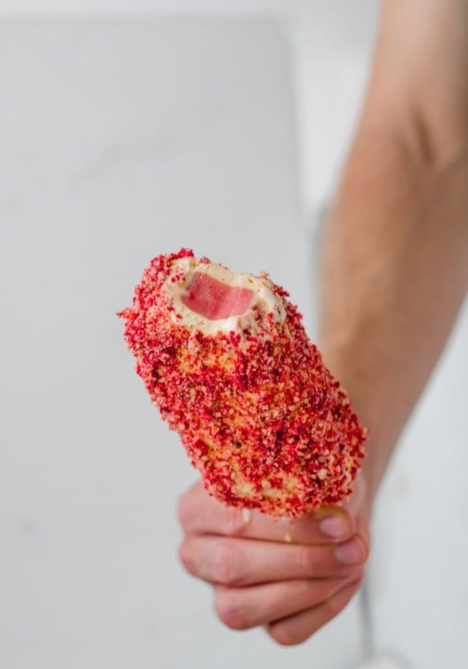 frozen strawberry shortcake bar held in a hand