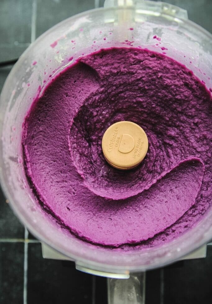 food processor with an overhead shot of whipped purple sweet potatoes