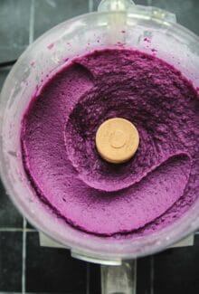 food processor with an overhead shot of whipped purple sweet potatoes